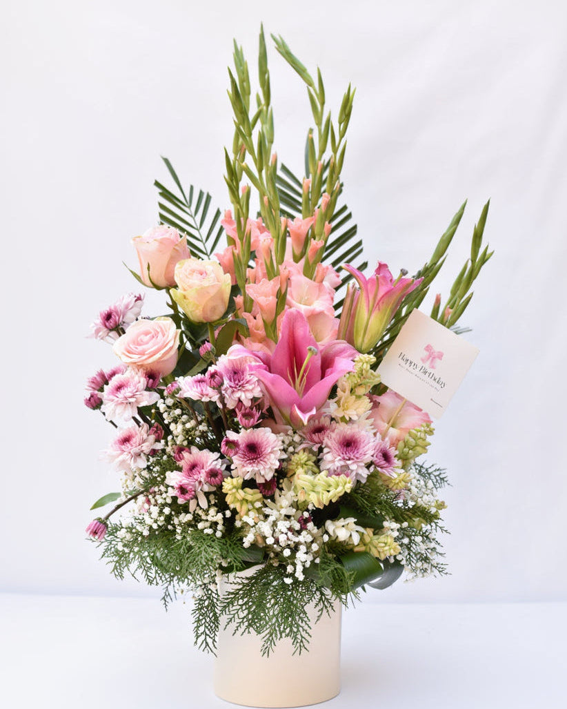 Bouquet of pink and green flowers with a tag on a white background